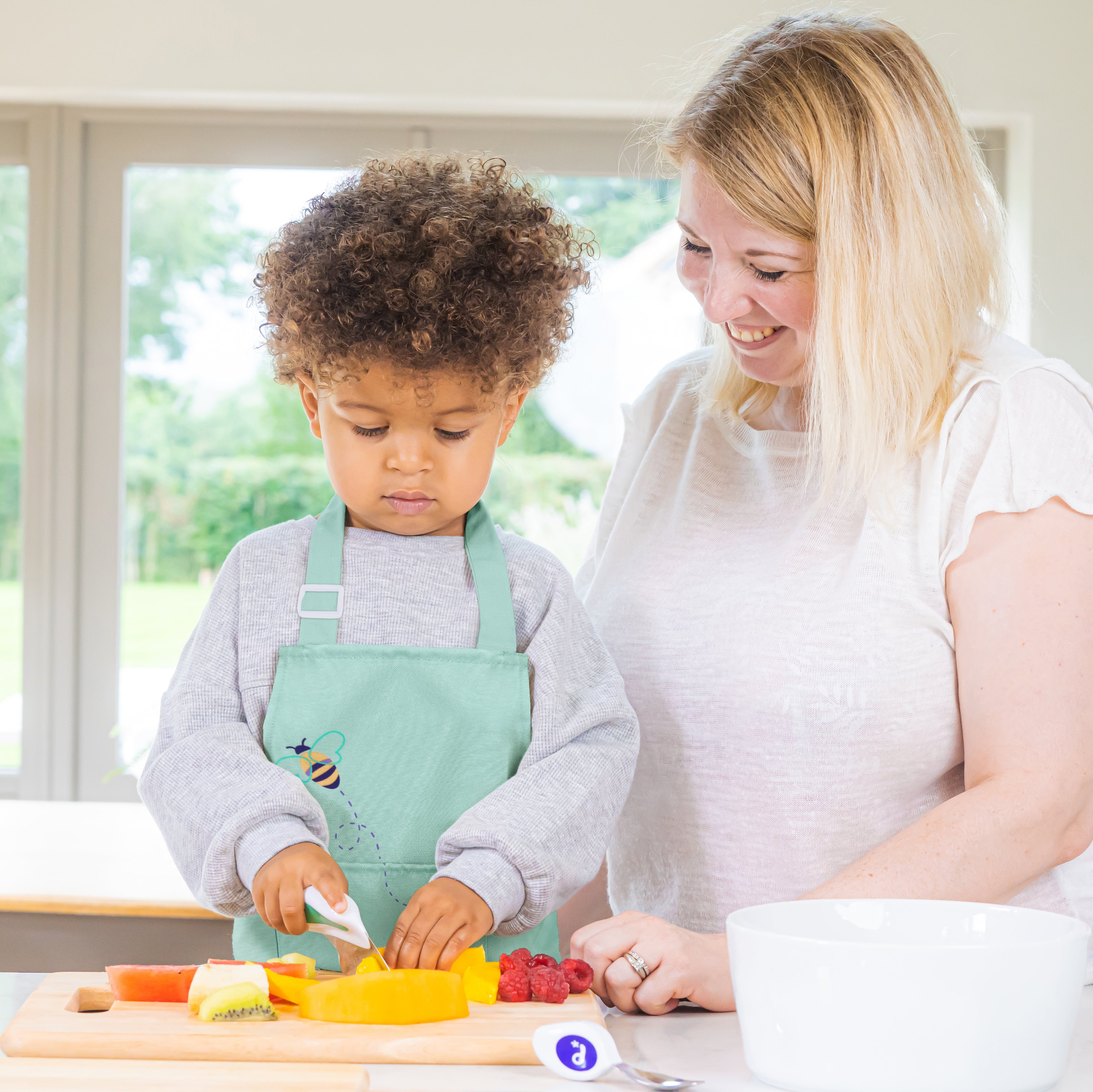 Woman and child in a kitchen preparing food together
