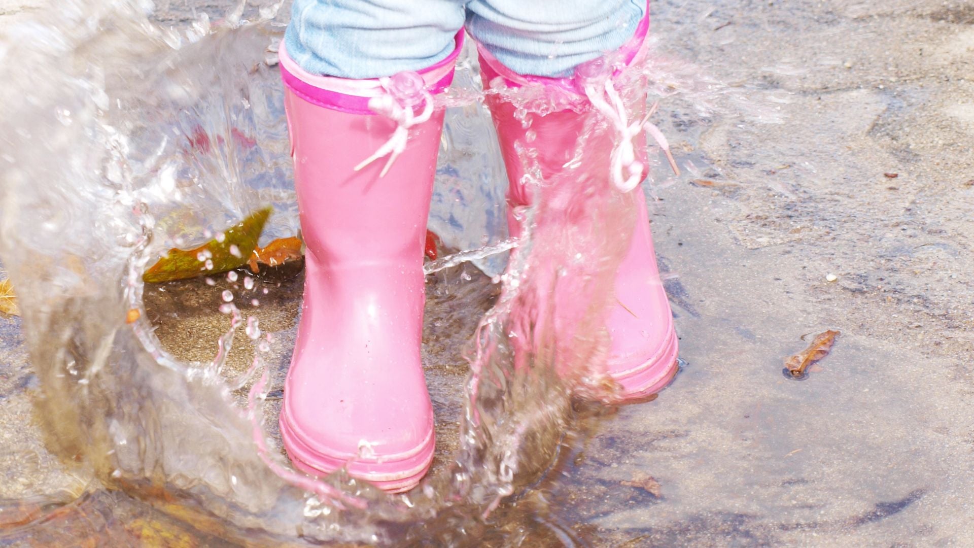 Top 4 Gross Motor Skills for Toddlers: A Guide for Parents - toddler in small pink wellies jumping in puddle