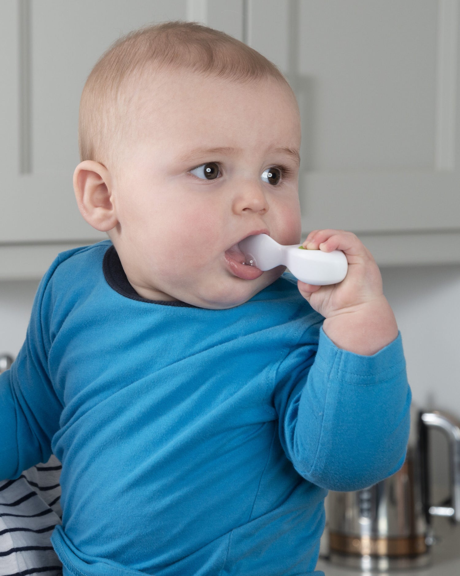 baby with spoon. Tips on Introducing Solid Foods to Your Baby - Weaning|toddler eating