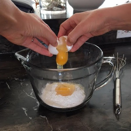 Pancake ideas for toddlers - breaking eggs into a bowl