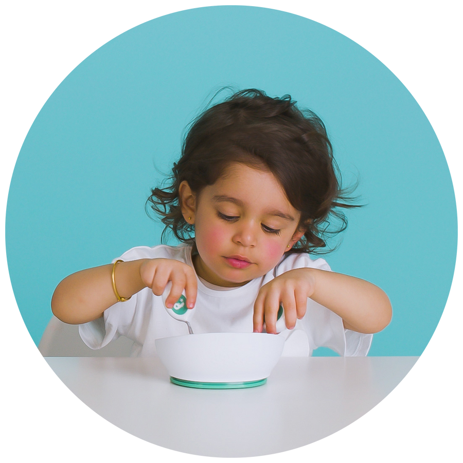 Young child eating from a doddl bowl at nursery