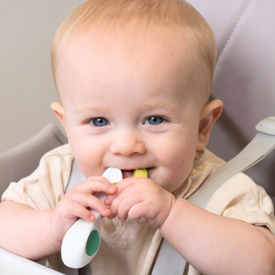 Baby smiling eating with doddl 