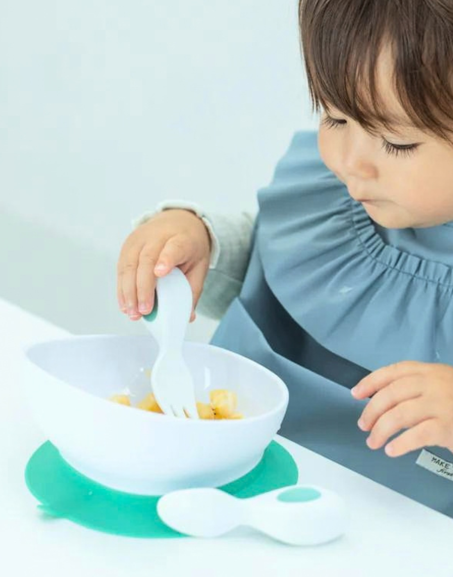 A parent and baby at the table