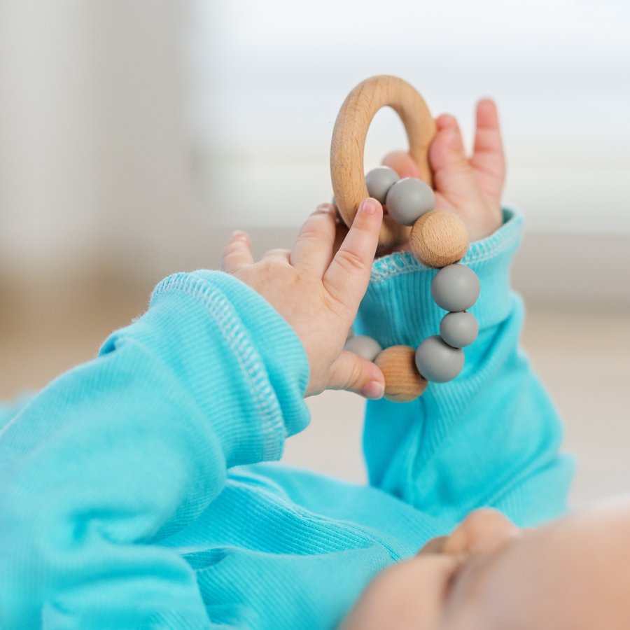A baby grasping different textures and shapes