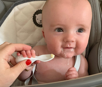 Baby being offered food on a doddl baby spoon